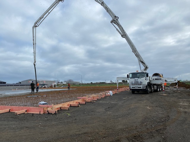 Concrete pump truck pouring a large floor